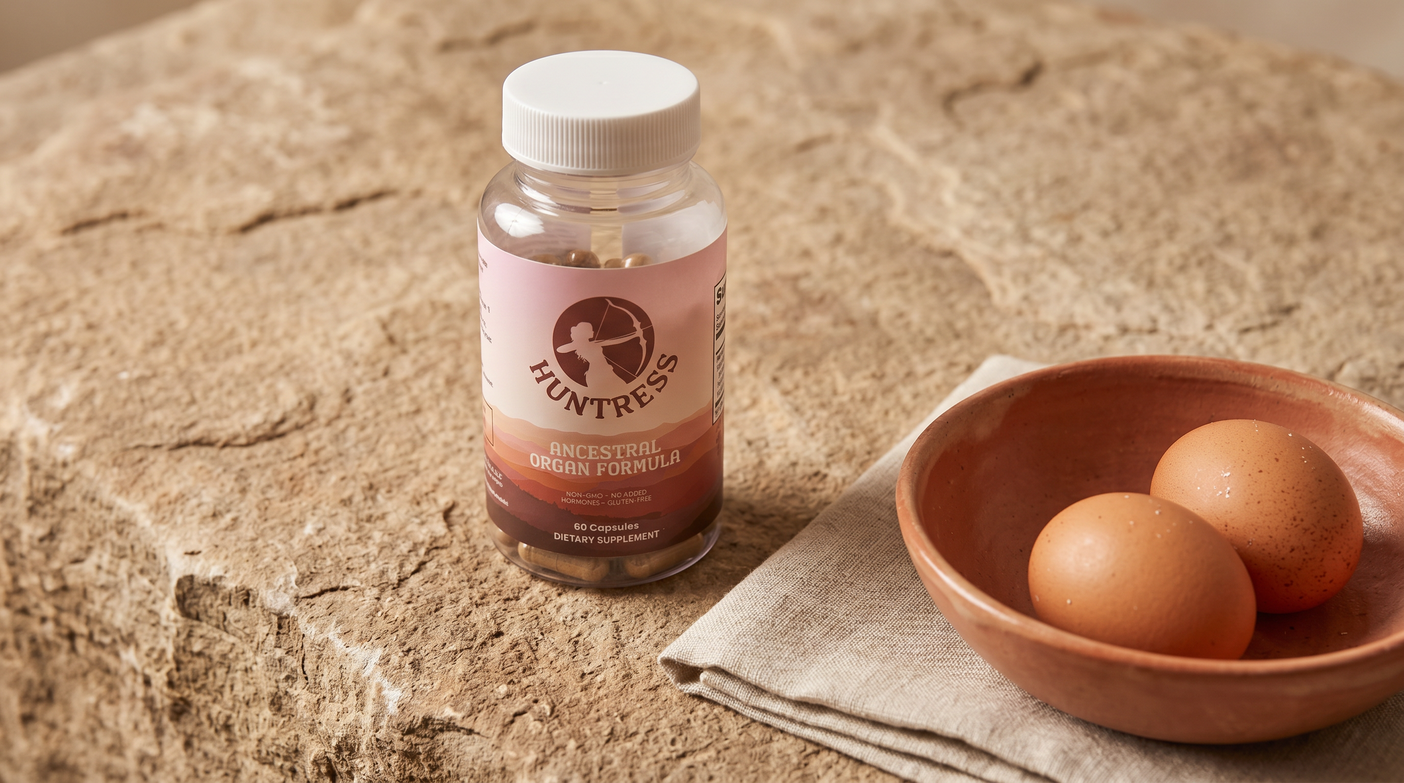 Huntress bottle on a stone surface with eggs and linen